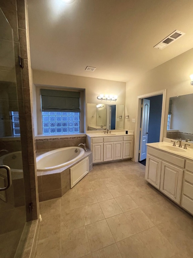 bathroom with vanity, shower with separate bathtub, and tile patterned floors