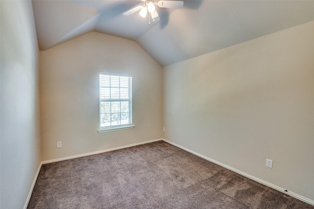 spare room with lofted ceiling, ceiling fan, and carpet