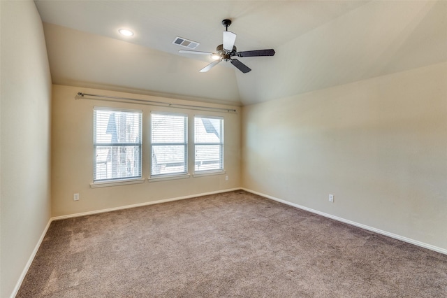 carpeted empty room featuring ceiling fan and vaulted ceiling