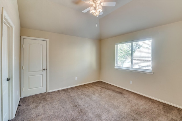 carpeted empty room with lofted ceiling and ceiling fan