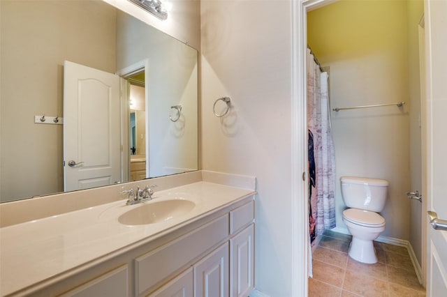 bathroom with vanity, toilet, and tile patterned flooring