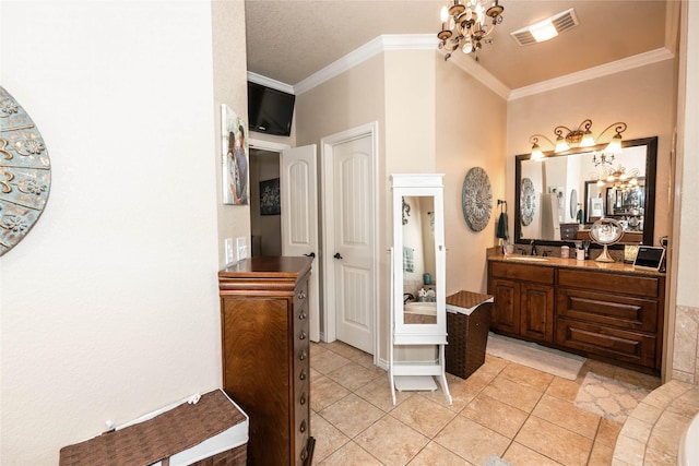 bathroom with ornamental molding, vanity, tile patterned flooring, and a notable chandelier