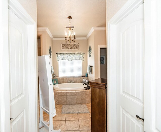 bathroom with a notable chandelier, ornamental molding, tile patterned flooring, and tiled tub