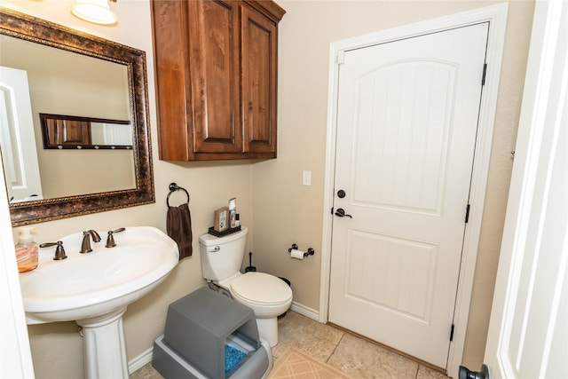 bathroom featuring tile patterned flooring and toilet