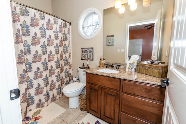 bathroom featuring vanity, toilet, and tile patterned flooring