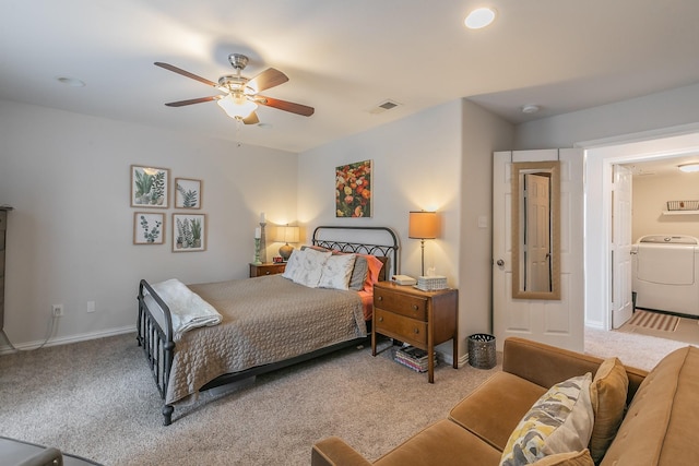 carpeted bedroom featuring washing machine and clothes dryer and ceiling fan