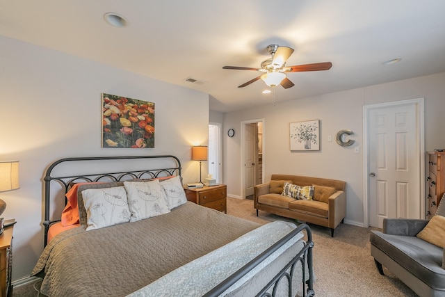 bedroom with ceiling fan and light carpet