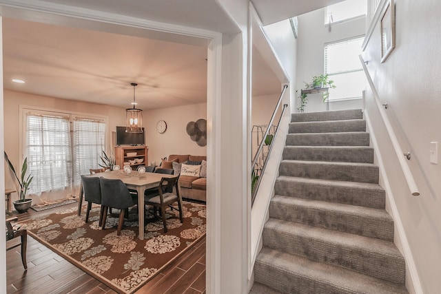 staircase with a healthy amount of sunlight and hardwood / wood-style floors