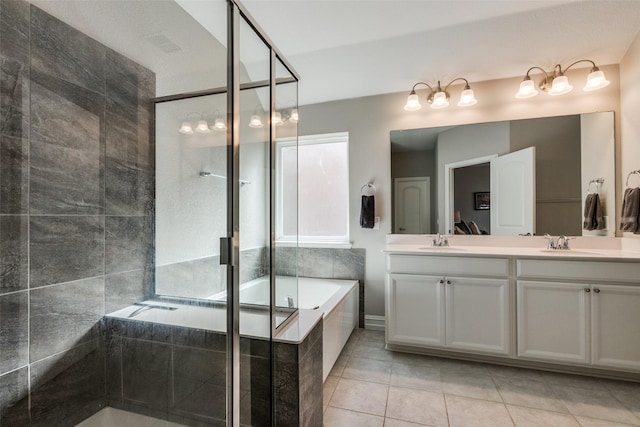 bathroom with tile patterned flooring, shower with separate bathtub, and vanity