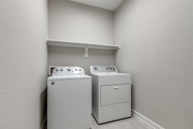 laundry room featuring washing machine and clothes dryer