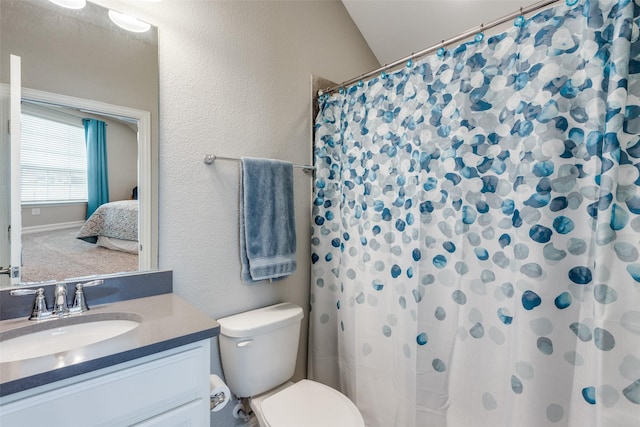 bathroom with vanity, a shower with shower curtain, and toilet