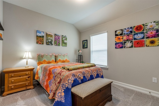 carpeted bedroom with lofted ceiling