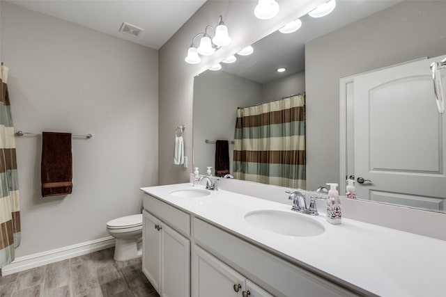 bathroom with vanity, hardwood / wood-style floors, and toilet