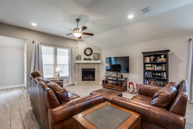 living room with vaulted ceiling, ceiling fan, and light wood-type flooring