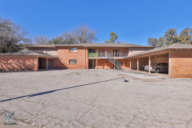 back of house with a carport