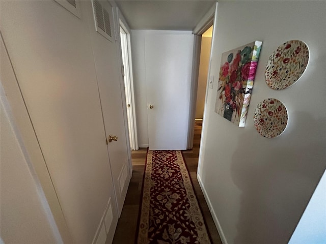 hallway with hardwood / wood-style floors