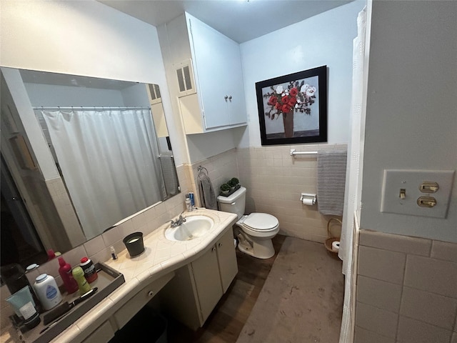 bathroom with vanity, tile walls, and toilet