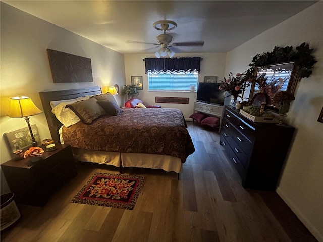 bedroom featuring dark wood-type flooring and ceiling fan