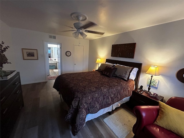 bedroom featuring dark wood-type flooring, ceiling fan, and ensuite bathroom