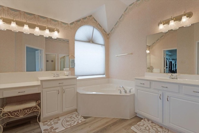 bathroom featuring vanity, hardwood / wood-style floors, and shower with separate bathtub