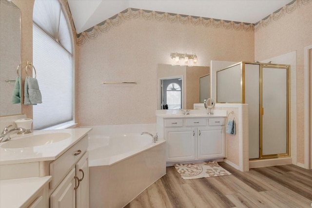 bathroom with lofted ceiling, vanity, shower with separate bathtub, and hardwood / wood-style floors