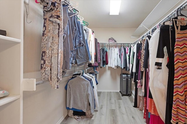 walk in closet with light wood-type flooring