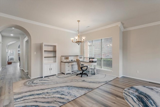 office space featuring crown molding, a healthy amount of sunlight, a chandelier, and wood-type flooring