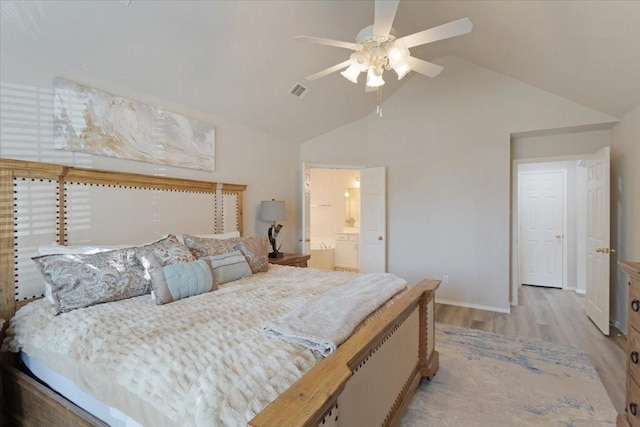 bedroom with high vaulted ceiling, ensuite bathroom, ceiling fan, and light wood-type flooring