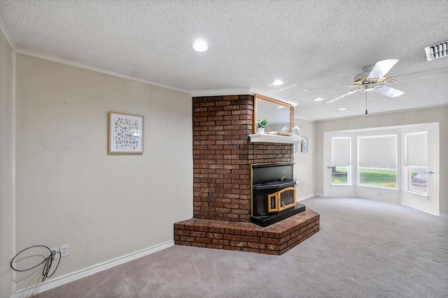 unfurnished living room with ceiling fan, carpet floors, ornamental molding, a textured ceiling, and a wood stove