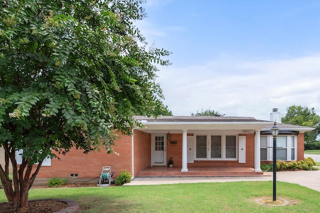 ranch-style home with a porch and a front lawn