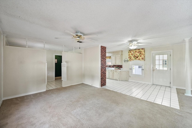 unfurnished living room featuring light colored carpet, a textured ceiling, and ceiling fan