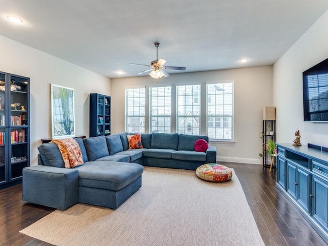 living room with ceiling fan and dark hardwood / wood-style flooring