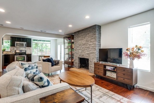 living room featuring dark hardwood / wood-style floors and a fireplace