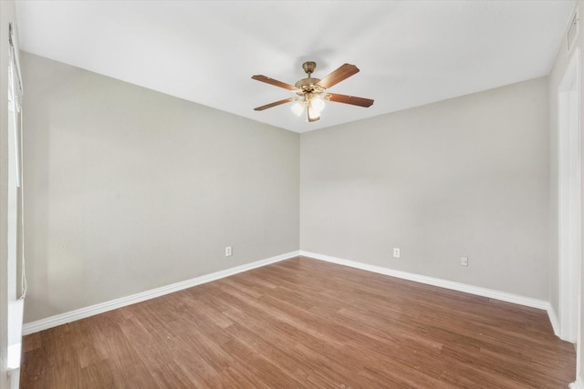 spare room with wood-type flooring and ceiling fan