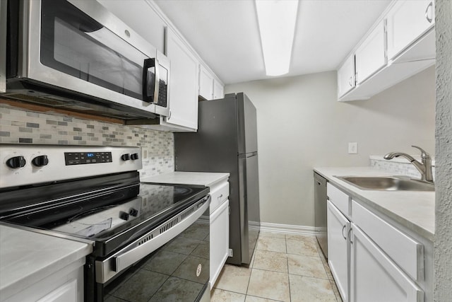 kitchen with light tile patterned flooring, white cabinetry, sink, backsplash, and stainless steel appliances