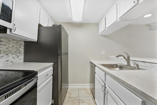 kitchen with white cabinetry, appliances with stainless steel finishes, sink, and decorative backsplash