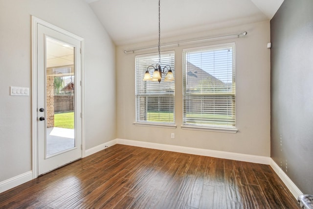 unfurnished dining area with an inviting chandelier, dark hardwood / wood-style floors, and vaulted ceiling