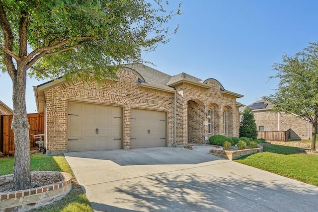 view of front of home with a garage and a front yard