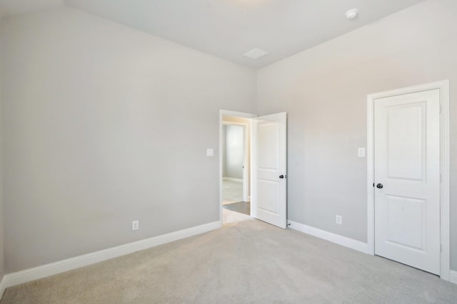 unfurnished bedroom featuring light carpet