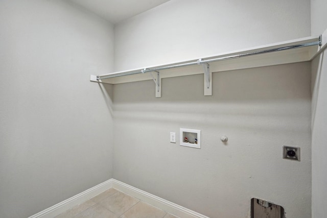 clothes washing area with gas dryer hookup, washer hookup, light tile patterned flooring, and electric dryer hookup