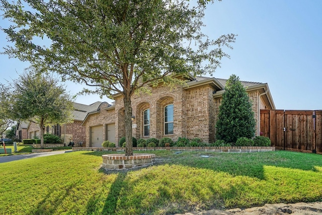 view of front of home with a garage and a front lawn