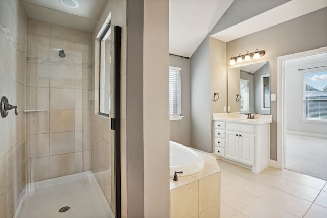 bathroom with tile patterned flooring, vanity, plenty of natural light, and independent shower and bath