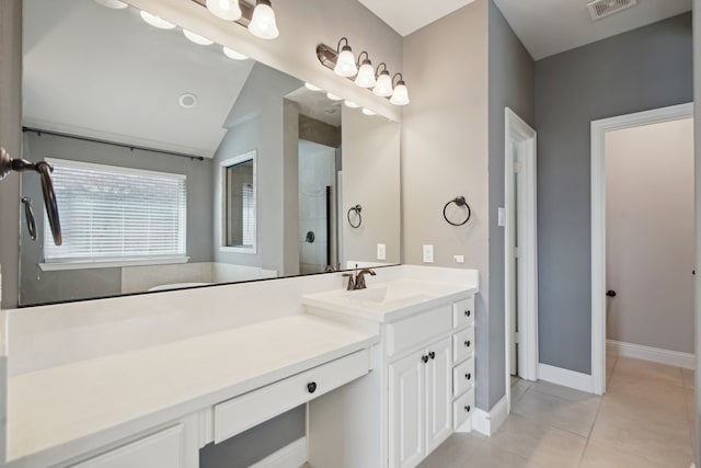 bathroom with vanity, tile patterned flooring, lofted ceiling, and a shower