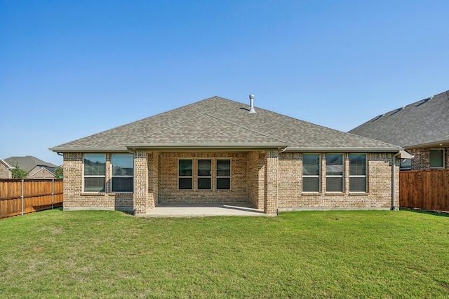 back of property featuring a yard and a patio