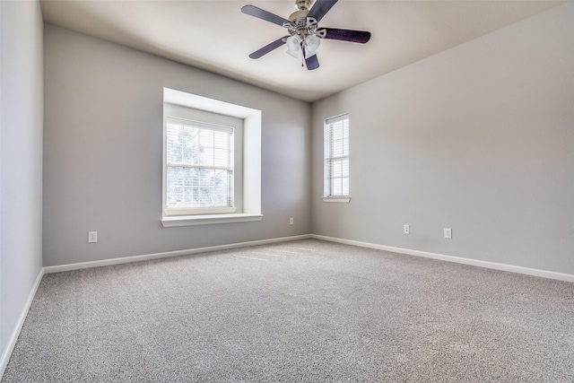 empty room featuring baseboards, a ceiling fan, and carpet
