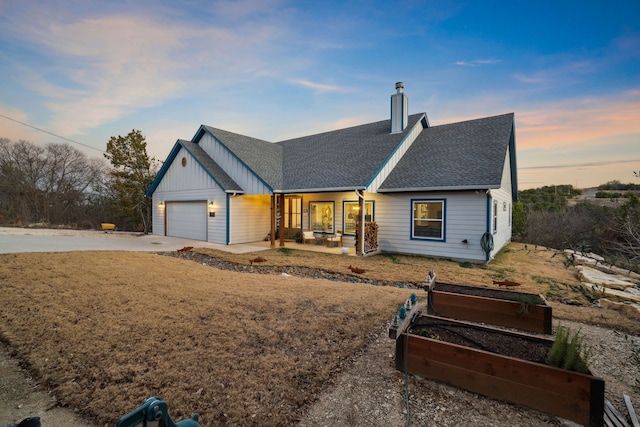 view of front of property featuring a garage and a lawn