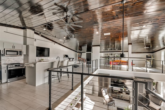 interior space featuring lofted ceiling and ceiling fan