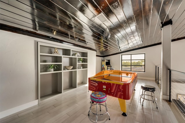 game room featuring wood ceiling, vaulted ceiling, light hardwood / wood-style floors, and built in features