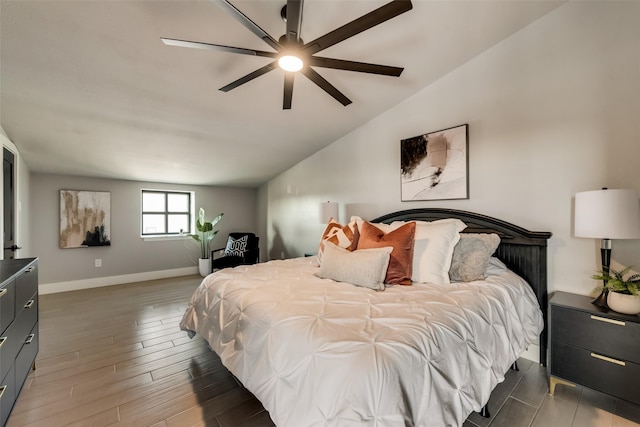 bedroom with dark hardwood / wood-style flooring, lofted ceiling, and ceiling fan