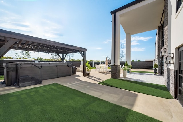 view of yard featuring a hot tub, a pergola, and a patio area